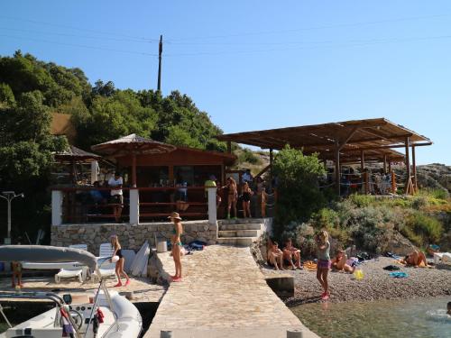 a group of people on the beach at a bar at Studio Apartments & Rooms Lela, Sipan island in Šipanska Luka