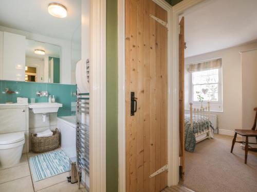 a bathroom with a toilet and a sink at Beckside Cottage in Welton