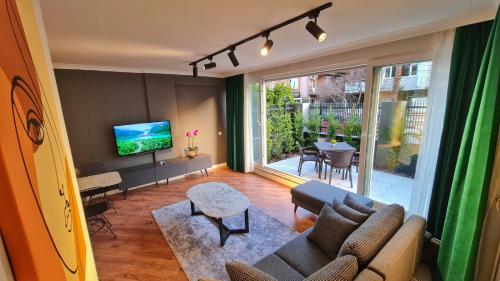 a living room with a couch and a tv at Letstay Sweet Home Yellow in Antalya