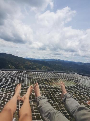 two people laying on top of a roof at Glamping La Montaña Sagrada in Medellín