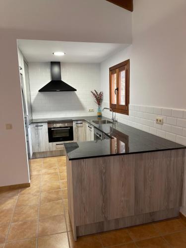 a large kitchen with a large island in the middle at Apartaments Cal Borda in Coll de Nargó