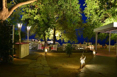 a patio with chairs and lights at night at Hotel Vlassis in Stómion
