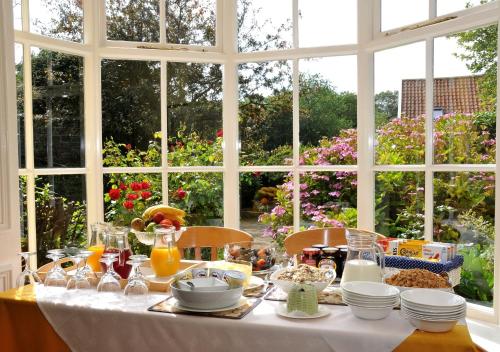 a table with a white table cloth and a window at Marton Grange Country House in Bridlington