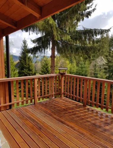 a wooden deck with a view of the mountains at Gierkówka - Górska Rezydencja Pierwszego Sekretarza in Zwardoń