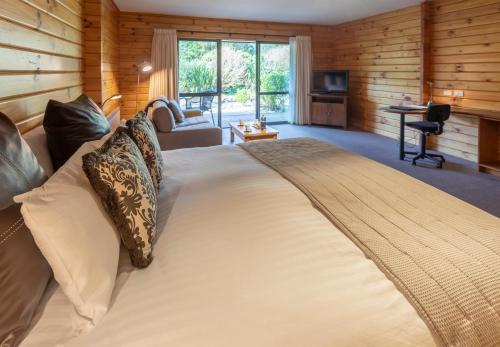 a bedroom with a large bed in a room at Westwood Lodge in Franz Josef