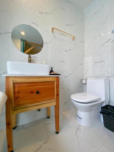 a bathroom with a sink and a toilet at Lacasa May in Da Lat