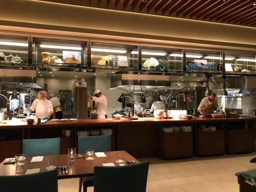 a group of chefs preparing food in a restaurant kitchen at Hiyori Ocean Resort Okinawa in Onna