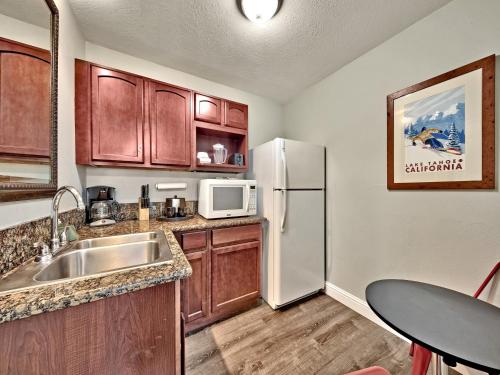 a kitchen with a sink and a refrigerator at Heavenly Inn Lake Tahoe in South Lake Tahoe