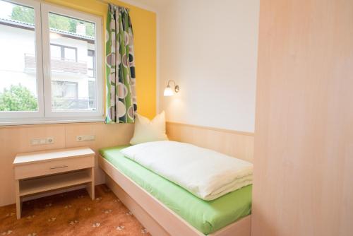 a small bedroom with a bed and a window at Apartment Österreich in Ramsau am Dachstein