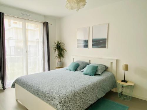 Кровать или кровати в номере Swann Disney Appartement