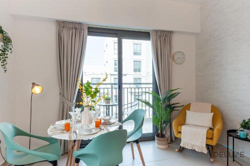 a dining room with a table and chairs and a balcony at Blissful 1BR in Safi Town Square by Deluxe Holiday Homes in Dubai