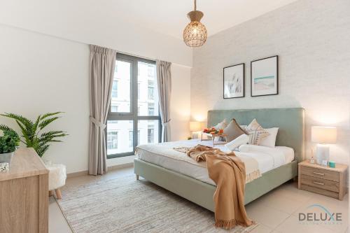 a bedroom with a bed and a large window at Blissful 1BR in Safi Town Square by Deluxe Holiday Homes in Dubai