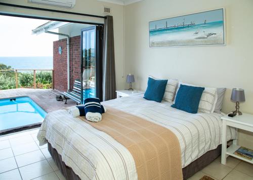 a bedroom with a bed and a swimming pool at Sea View townhouse in Zinkwazi Beach in Zinkwazi Beach