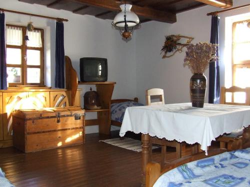 a living room with a table and a tv at Csátó Vendégház in Tihany