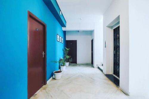 a hallway with blue and white walls and a door at ELITE ROOMS in Hyderabad