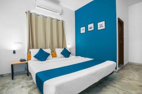 a blue and white bedroom with a large bed at ELITE ROOMS in Hyderabad