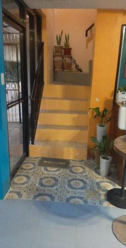 a hallway with stairs and a floor with a tile floor at West Atlantic Inn in Concepcion