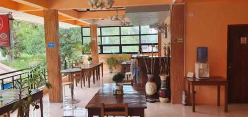 a restaurant with tables and chairs in a room at West Atlantic Inn in Concepcion