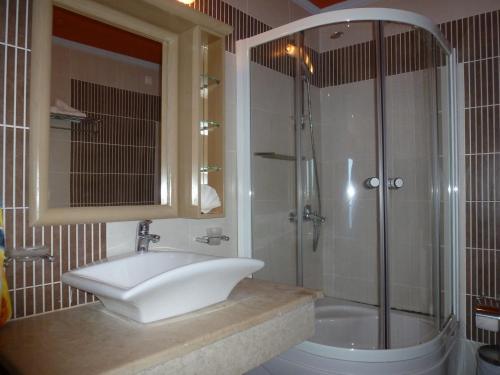 a bathroom with a sink and a shower at Plaza Hotel in Masouri