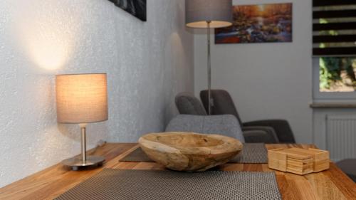 a wooden table with a wooden bowl on top of it at Suit' & Frühstück Zum Latschen - Adults Only in Mauth