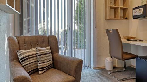 a living room with a couch and a sliding glass door at Suit' & Frühstück Zum Latschen - Adults Only in Mauth
