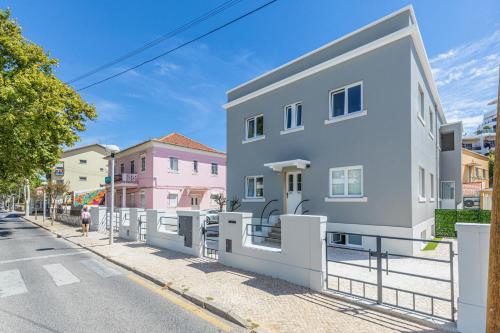 a white building on the side of a street at Sweet Spot @ Beach in Estoril