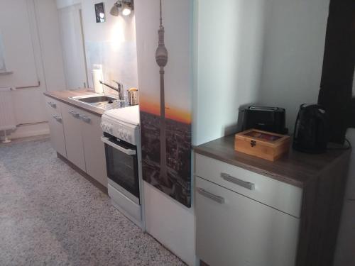 a kitchen with a sink and a stove top oven at Ferienwohnung Jansen "Zwei" in Bad Schwalbach