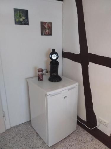 a small refrigerator with a clock on top of it at Ferienwohnung Jansen "Zwei" in Bad Schwalbach