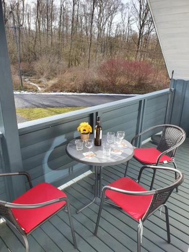a table and two chairs on a porch with a table and chairs at Silbersee90 in Frielendorf