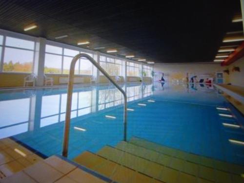 a large swimming pool with a ramp in a building at App 350 mit Brockenblick in Braunlage