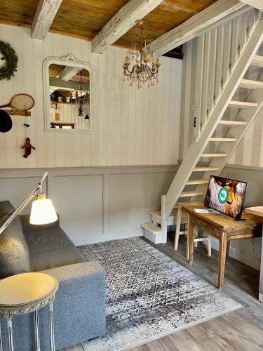 a living room with a staircase and a couch at La Ferme de Marie in Rangen