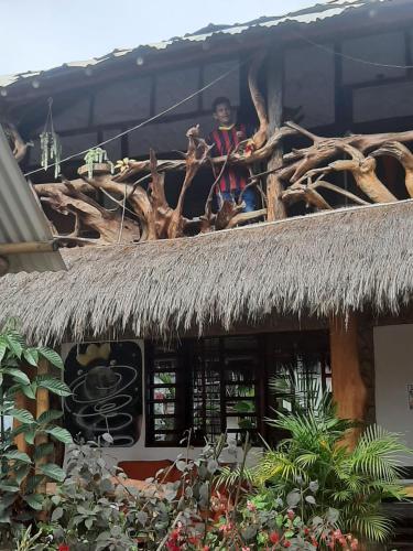 a person sitting on the top of a building at Cabañas Guacari San Agustín huila in San Agustín