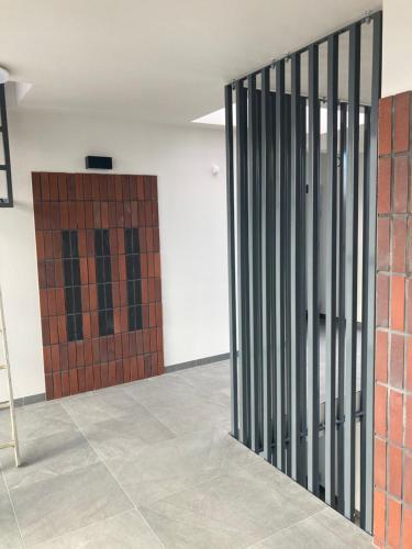 a metal gate in a room with a door at JAB Apartament Przy Klinice Business & Family in Szczecin