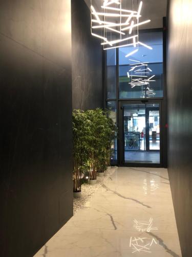 a hallway with potted plants in front of a building at Amare Luxury Apartments in Budva