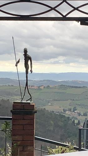 a statue of a man holding two swords on top of a building at Casa Panzano Tuscany in Panzano