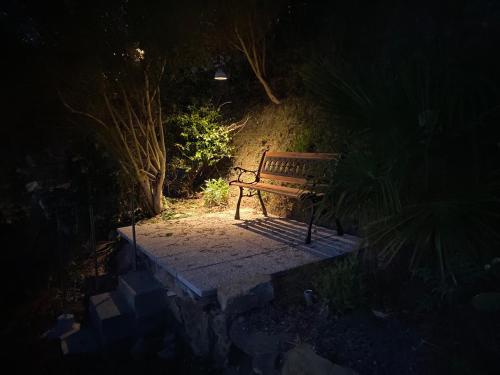 a park bench sitting on a path at night at Casa Panzano Tuscany in Panzano