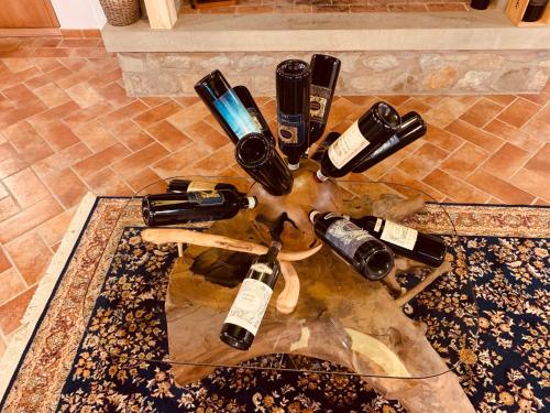 a bunch of wine bottles sitting on top of a rug at Casa Panzano Tuscany in Panzano