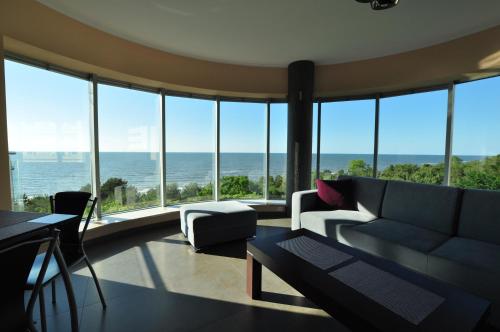 a living room with a couch and a view of the ocean at Promenada28pl - Apartamenty z widokiem na morze in Międzyzdroje