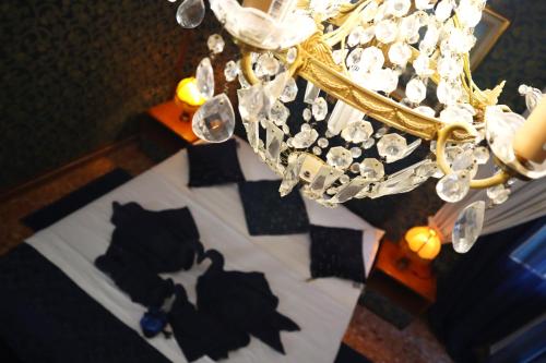 a chandelier with a shadow of a cat on a bed at VENICE RAINBOW APARTMENT (RIALTO) in Venice