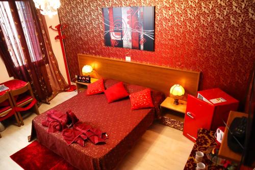 a bedroom with a red bed with red pillows at VENICE RAINBOW APARTMENT (RIALTO) in Venice
