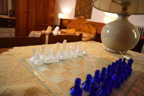 a chess board on a table with blue chess pieces at VENICE RAINBOW APARTMENT (RIALTO) in Venice