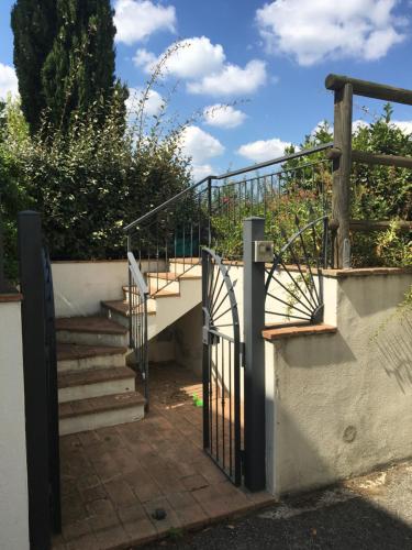 a set of stairs with a wrought iron gate at Casa Panzano Tuscany in Panzano