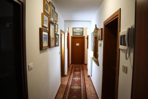 a hallway with many doors and a rug on the floor at VENICE RAINBOW APARTMENT (RIALTO) in Venice