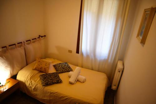 a bedroom with a bed with two towels on it at VENICE RAINBOW APARTMENT (RIALTO) in Venice