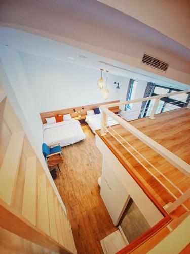a living room with a staircase leading up to a loft at 埔里隱巷人文行旅民宿 in Puli