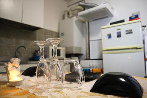 two wine glasses sitting on top of a kitchen counter at VENICE RAINBOW APARTMENT (RIALTO) in Venice