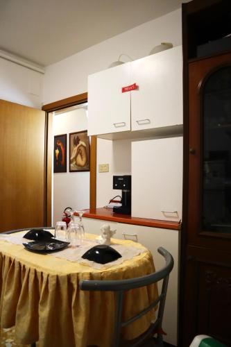 a kitchen with a table with a yellow table cloth on it at VENICE RAINBOW APARTMENT (RIALTO) in Venice