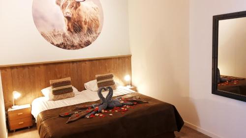 a bedroom with a bed with a picture of a deer on the wall at Beach Hotel Oostvoorne in Oostvoorne