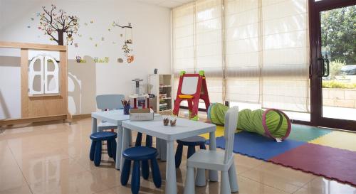 a play room with a table and chairs at Marko Polo Maradiso Hotel by Aminess in Korčula