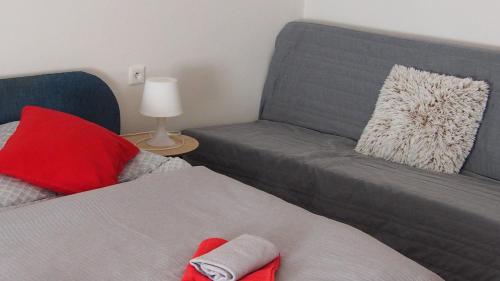 a bedroom with a couch and a bed and a chair at Penzion a Restaurace Na Jízdárně in Kroměříž